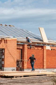 Spring day, workers make the finish facade of the house Stock Photos