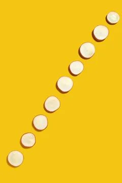 Spring diagonal pattern from fresh radish slices on a yellow background wi... Stock Photos
