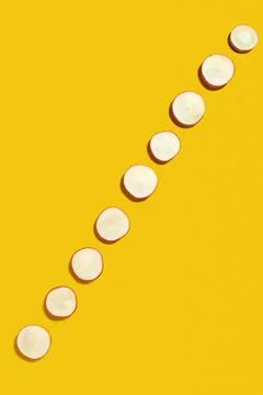 Spring diagonal pattern from fresh radish slices on a yellow background wit.. Stock Photos