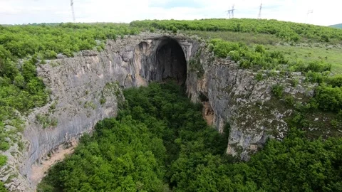 Spring Drone View of Prohodna Cave "God's Eyes" near Karlukovo, 2019 BG Stock Footage 323382622