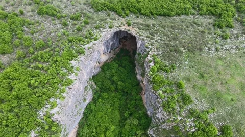 Spring Drone View of Prohodna Cave "God's Eyes" near Karlukovo, BG 2019 Stock Footage 323382817