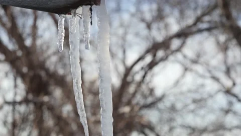 Spring drops, melting icicles hanging from the drain. Stock Footage 149312297