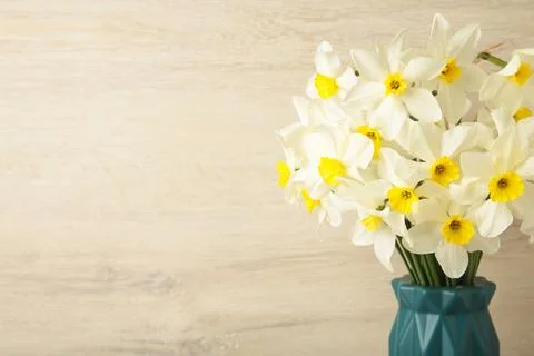 Spring easter background with daffodils bouquet in vase on light background.  Stock Photos