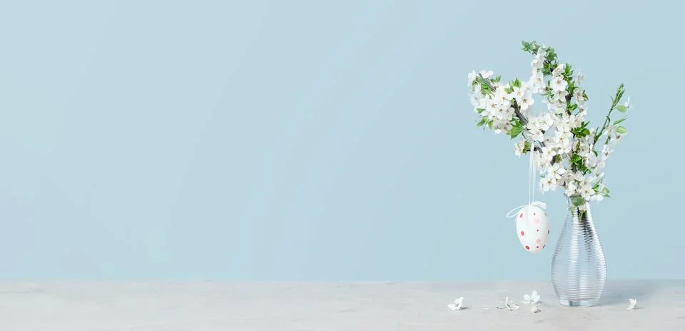 Spring Easter blooming tree branches in a vase on tender blue Stock Photos