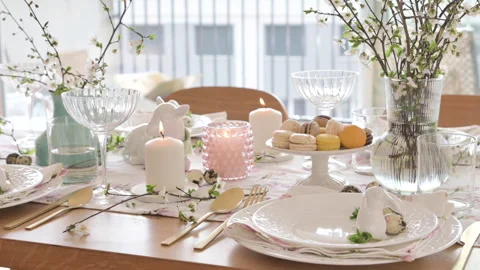 Spring Easter decor. Easter table setting. Flowers and dishes and candles for a Video stock 268073632