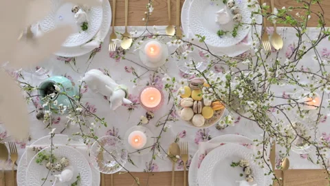 Spring Easter decor. Easter table setting. Flowers and dishes and candles for a Stock Footage 270244328