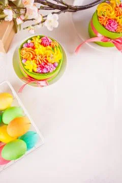 Spring Easter festive table. Two small green cake with butter cream flowers a Stock Photos