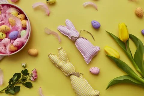 Spring Easter post card concept. Pink bowl with colorful eggs, pink feathers Stock Photos