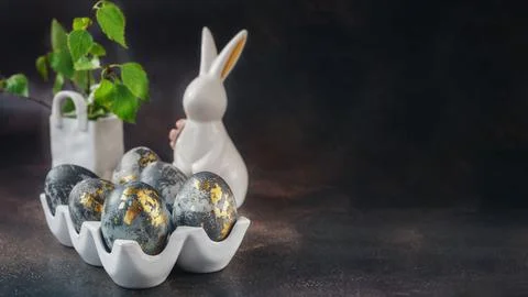 Spring Easter still life. White rabbit and eggs painted with gold pattern o.. Stock Photos