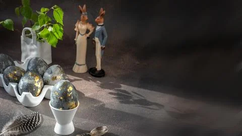 Spring Easter still life. White rabbit and eggs painted with gold pattern in  Stock Photos