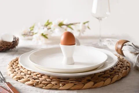 Spring Easter table setting with organic eggs, bunny and blooming flowers. Stock Photos