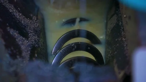 The spring in the emulsion flushes the metal shavings Band Saw Machine Stock Footage