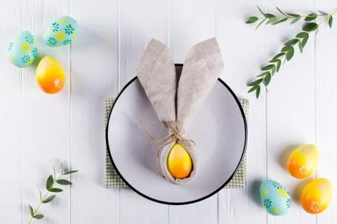 Spring festive Easter table setting with bunny ears linen  napkin Stock Photos