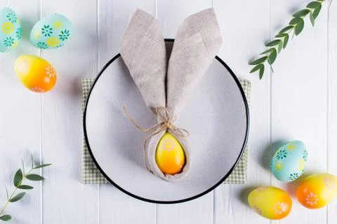 Spring festive Easter table setting with bunny ears linen  napkin Stock Photos