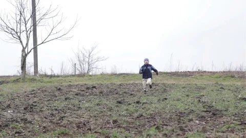 Spring field boy running Stock Footage 73077408