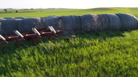 Spring Field with old bales and equipment Stock Footage 109243756