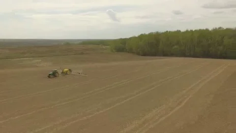 Spring field with a tractor Round shot Stock Footage 69125343