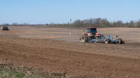 Spring field work. The tractor plows the ground. Preparation for sowing agric Stock Photos
