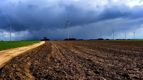 Spring fields with windmills under cloudy sky. Polish spring landscape Stock Footage 251318808