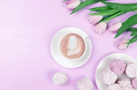 Spring Flat lay.White cup with coffee, pink tulips and marshmallows. copy space Stock Photos