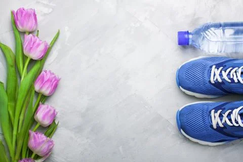 Spring flatlay composition with sneakers and tulips. Stock Photos
