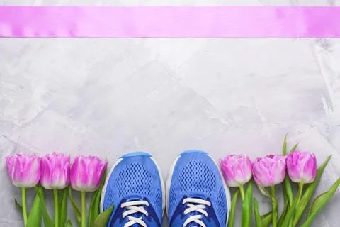 Spring flatlay composition with sneakers and tulips. Stock Photos