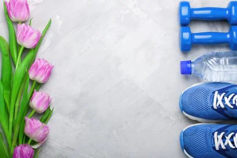 Spring flatlay composition with sport equipment and tulips. Stock Photos