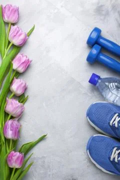 Spring flatlay composition with sport equipment and tulips Stock Photos