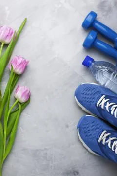 Spring flatlay composition with sport equipment and tulips Stock Photos