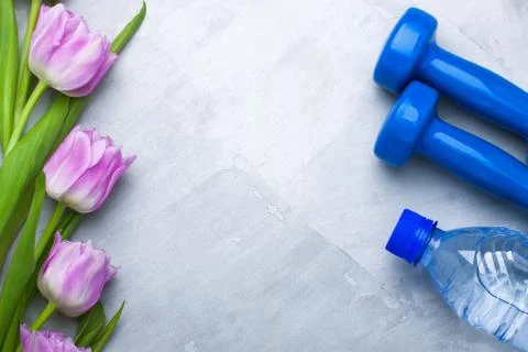 Spring flatlay composition with sport equipment and tulips Stock Photos