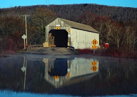 SPRING FLOOD COVERED BRIDGE Stock Photos