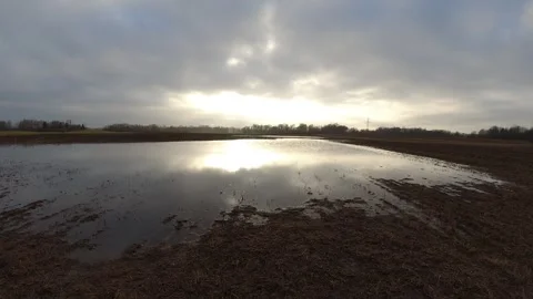 Spring flood puddles in farm fields and clouds motion, time lapse 스톡 동영상 293712368