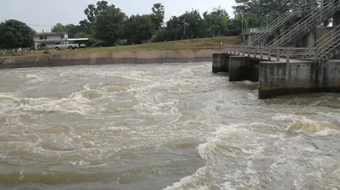 Spring flood water whirlpool flowing on hydroelectric power station dam Stock Footage 12204485