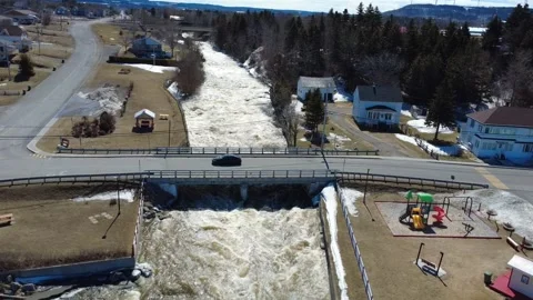 Spring Flood Waters Beneath Small Bridge in Saint-Ulric-de-Matane Stock Footage 335793087
