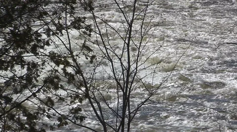 Spring flooding and rushing water after long cold snowy winter Stock Footage 39355252
