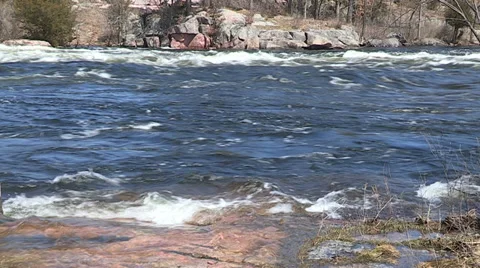 Spring flooding and rushing water after long cold snowy winter Stock Footage 39356724