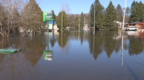 Spring flooding and rushing water after long cold snowy winter Stock Footage 39370117