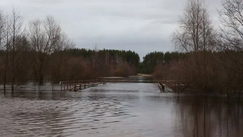 Spring floods. A flooded bridge overflowing from the banks of the river. Stock Footage 237385562