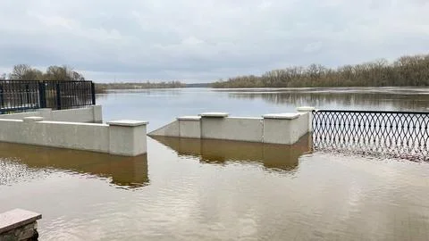Spring floods that flooded the paths on the river boardwalk. Stock Photos