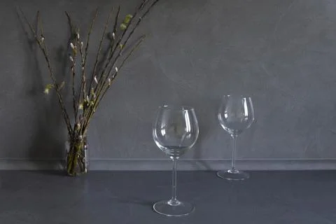 Spring, flowering willow and two glasses on a gray background. Stock Photos