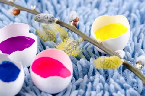 Spring flowers and Easter egg shells filled with colorful paints Stock Photos