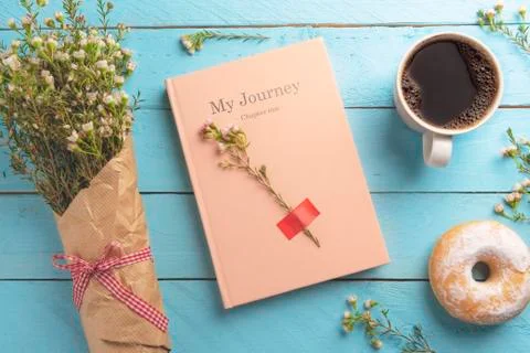 Spring flowers and a pink notebook with a delicious breakfast. Flat lay image Stock Photos