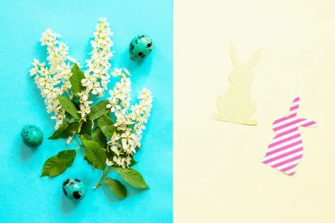 Spring flowers, Easter eggs, bunny on a blue and yellow background. Stock Photos