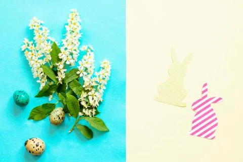 Spring flowers, Easter eggs, bunny on a blue and yellow background. Stock Photos