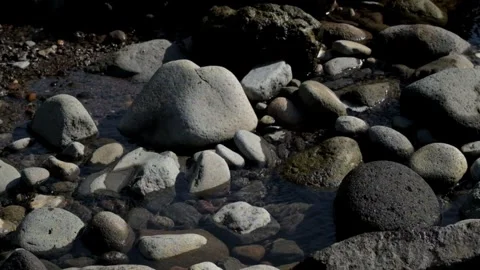 The spring flows through the river rocks Stock Footage 287289932