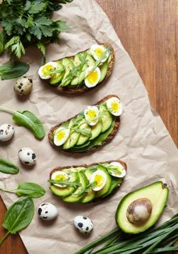 Spring food. A whole grain bread toast sandwiches with avocado, spinach Stock Photos