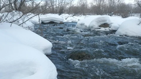 Spring forest river. Melting ice on the river, white snow on the river banks Stock Footage 125292495