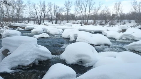 Spring forest river. Melting ice on the river, white snow on the river banks Stock Footage 125292772
