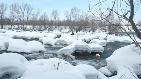 Spring forest river. Melting ice on the river, white snow on the river banks Stock Footage 125297035