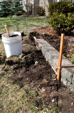 Spring garden and yard work - repairing of flower beds Stock Photos